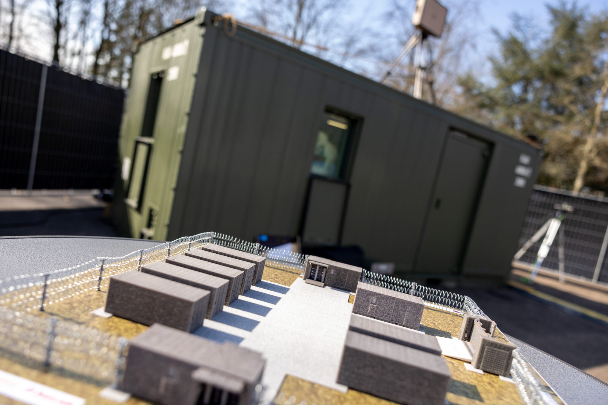 Miniature military field with small boxes representing large containers